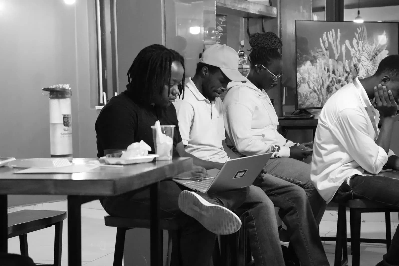 Builders gathered around a table of laptops.